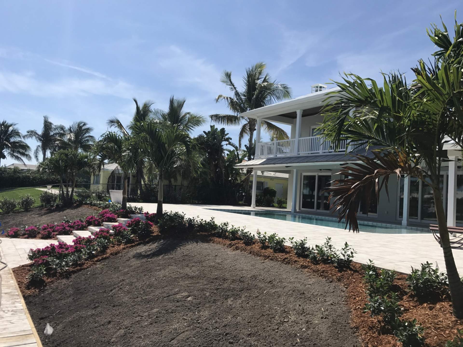 House view from the back, with trees and flowers